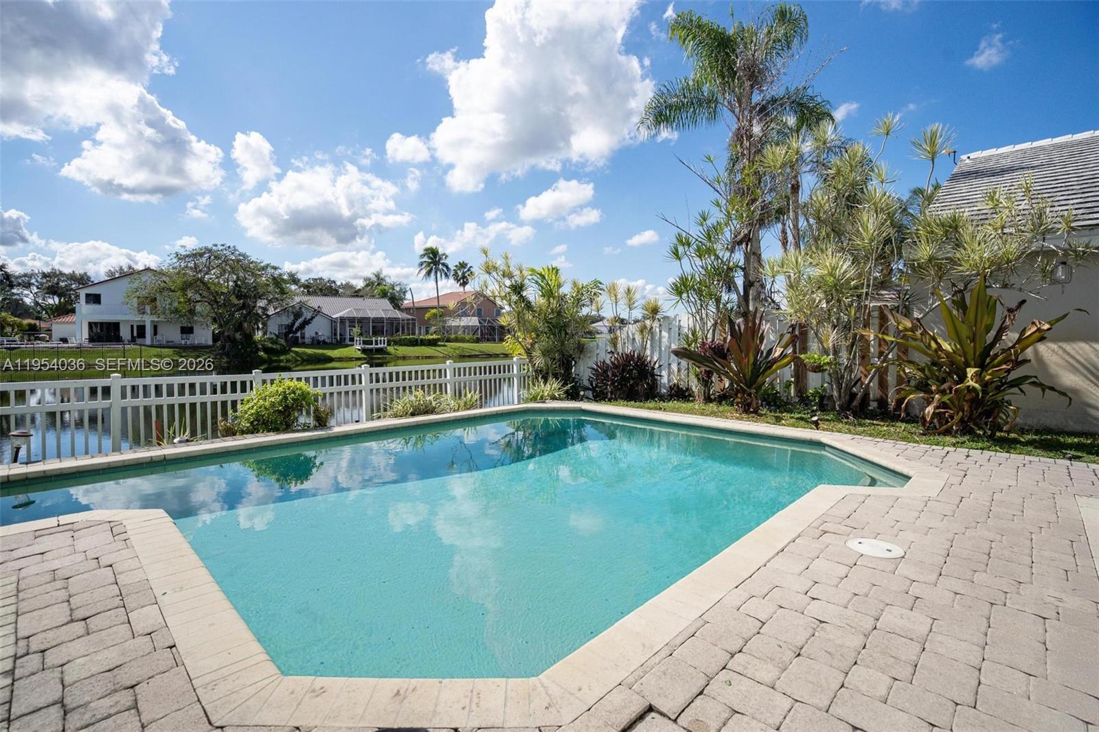 13930 Oak Ridge Drive Davie, FL 33325 - Photo 9 of 54 a view of a swimming pool and a yard