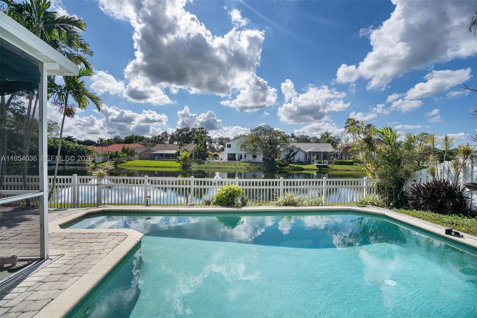 13930 Oak Ridge Drive Davie, FL 33325 - Photo 10 of 54 a view of a swimming pool with a patio