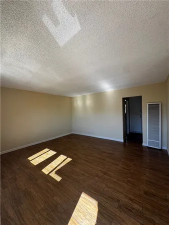 a view of an empty room and wooden floor