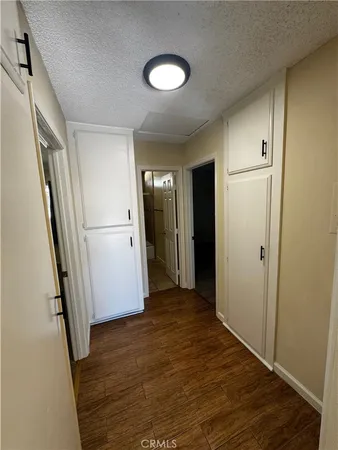a view of a hallway with wooden floor
