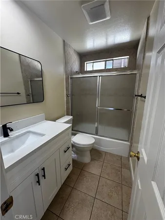 a bathroom with a toilet sink and shower
