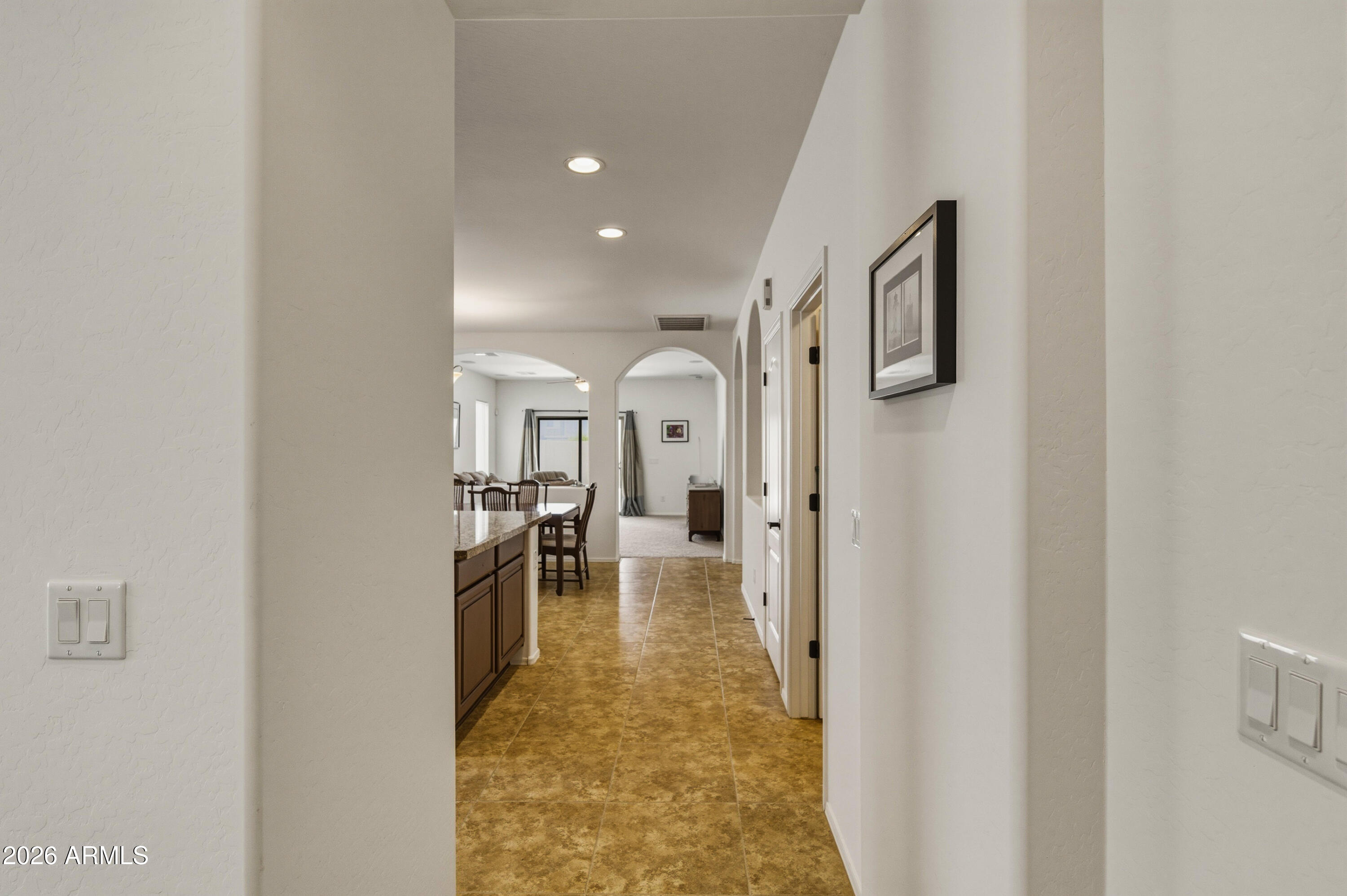 38061 West Merced Street Maricopa, AZ 85138 - Photo 12 of 49 a view of a hallway with the view of living room with furniture