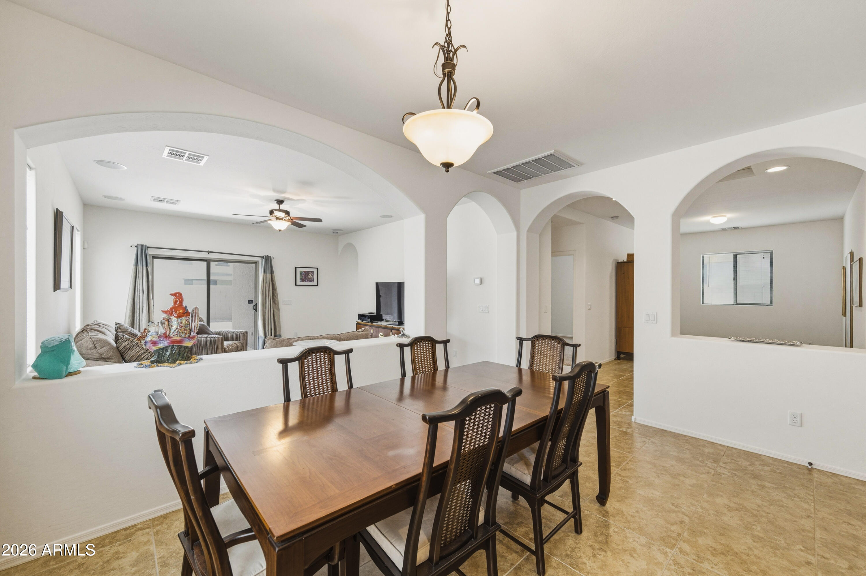 38061 West Merced Street Maricopa, AZ 85138 - Photo 18 of 49 a view of a dining room with furniture and chandelier
