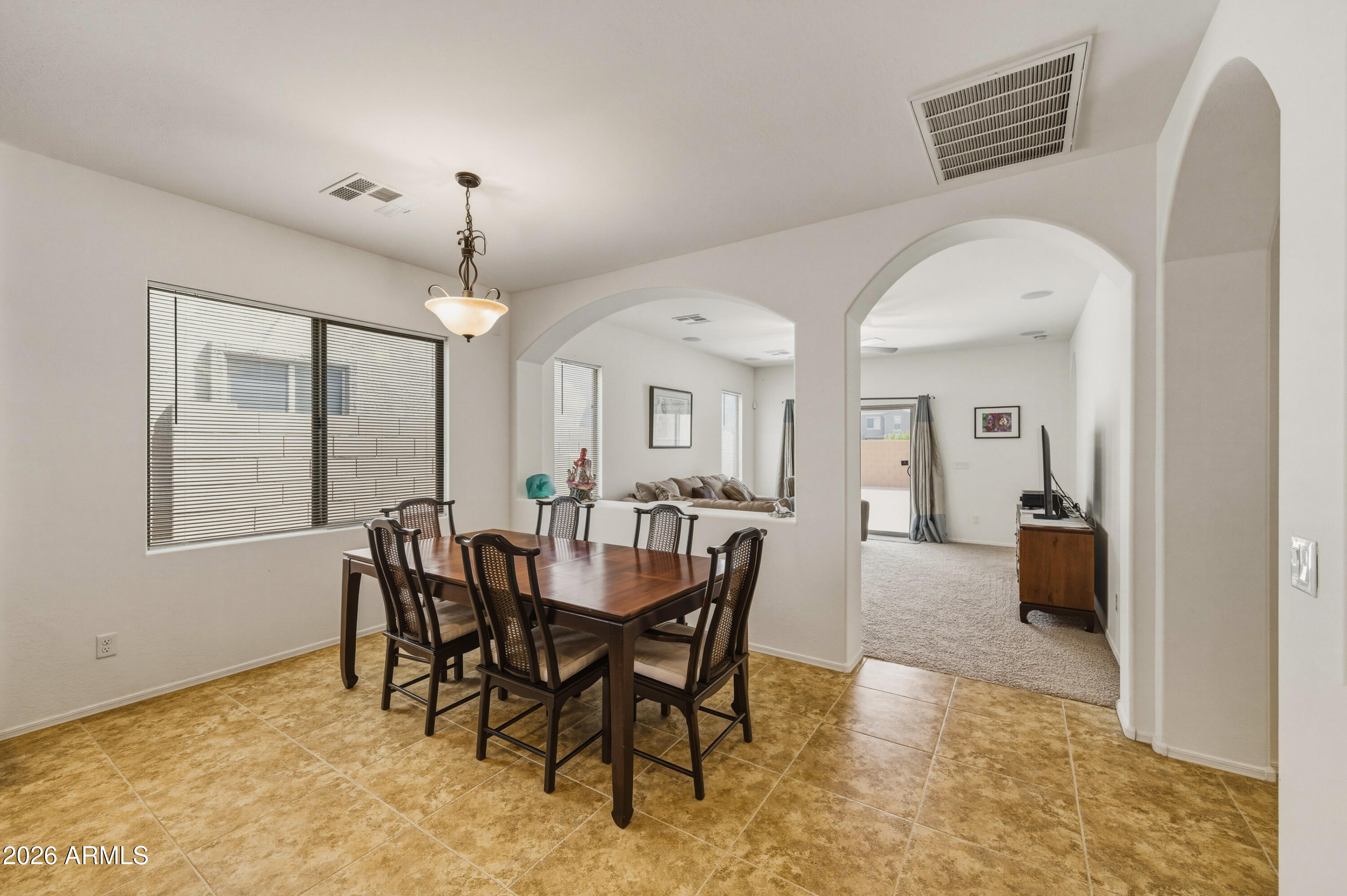 38061 West Merced Street Maricopa, AZ 85138 - Photo 19 of 49 a view of a a dining room with furniture window and wooden floor