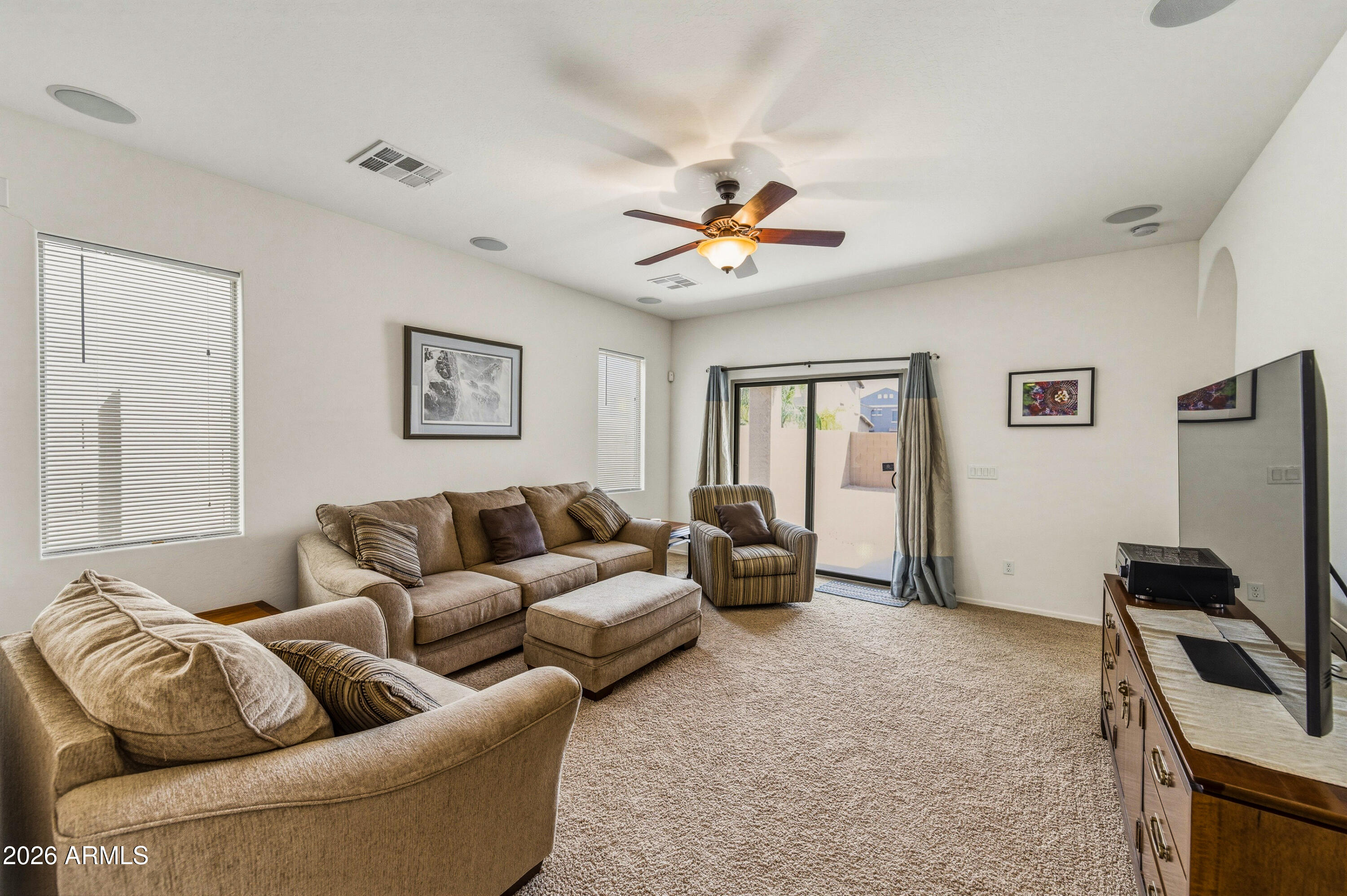 38061 West Merced Street Maricopa, AZ 85138 - Photo 21 of 49 a living room with furniture ceiling fan and a window