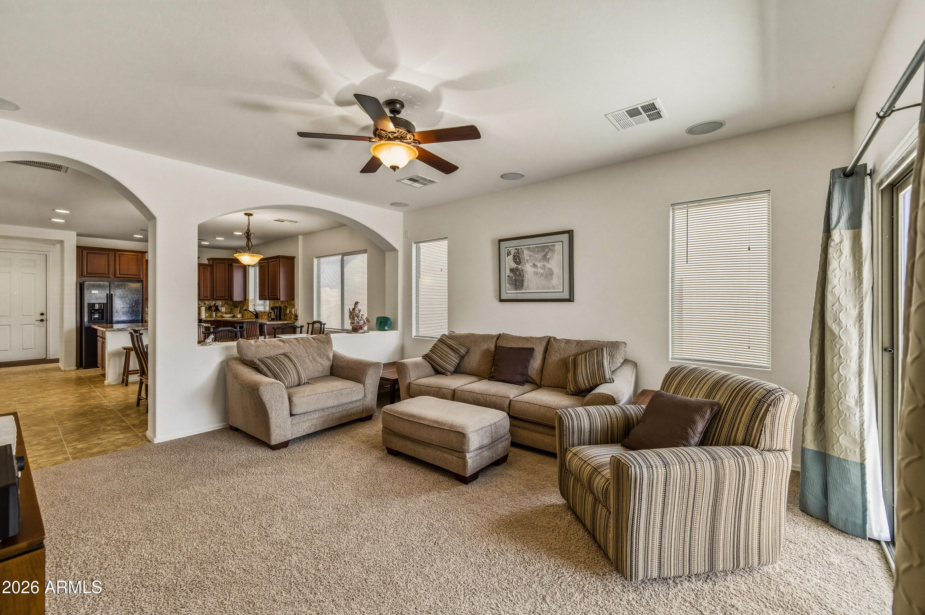 38061 West Merced Street Maricopa, AZ 85138 - Photo 22 of 49 a living room with furniture and a chandelier