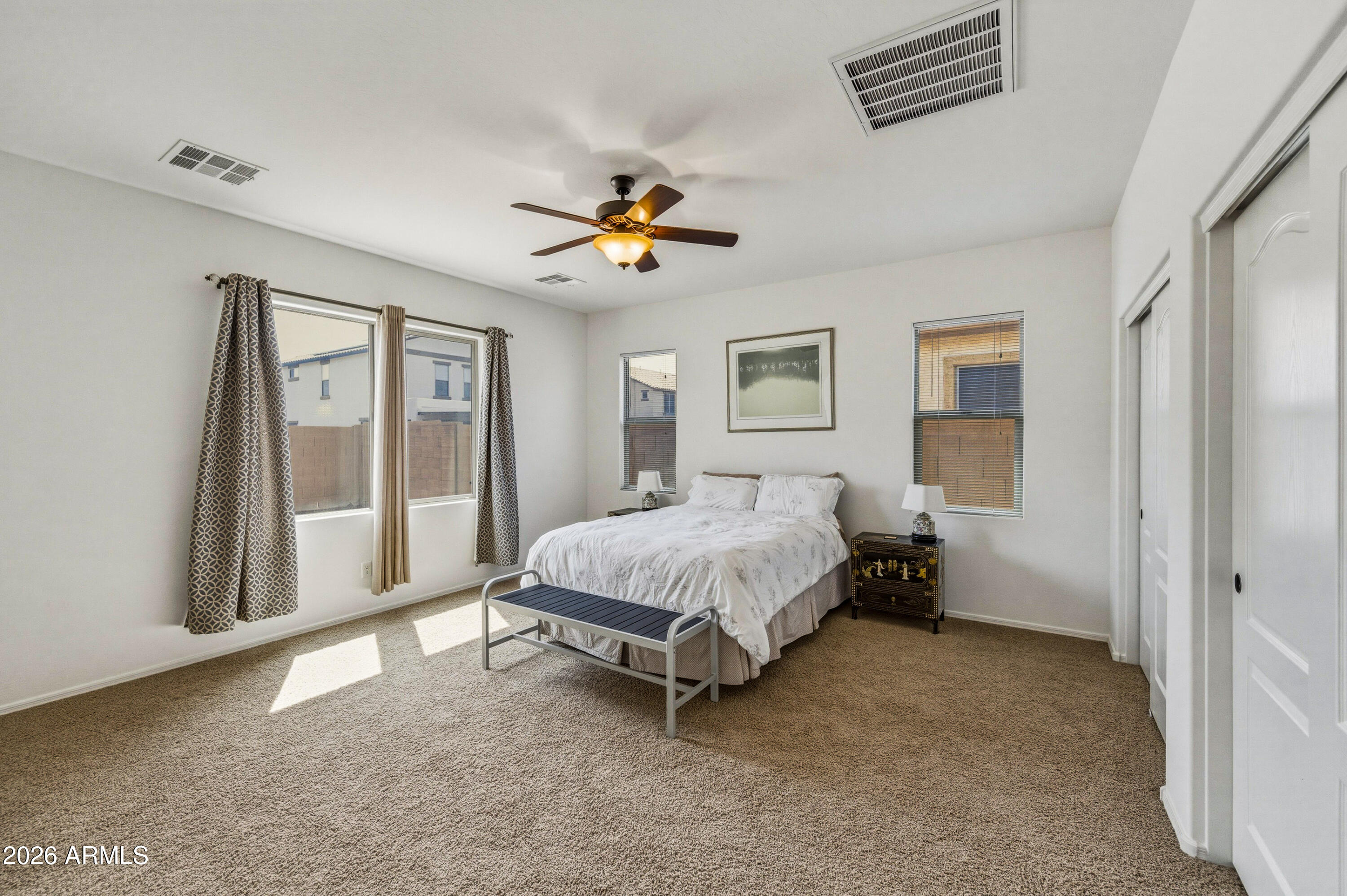 38061 West Merced Street Maricopa, AZ 85138 - Photo 23 of 49 a bed sitting in a spacious bedroom next to a window