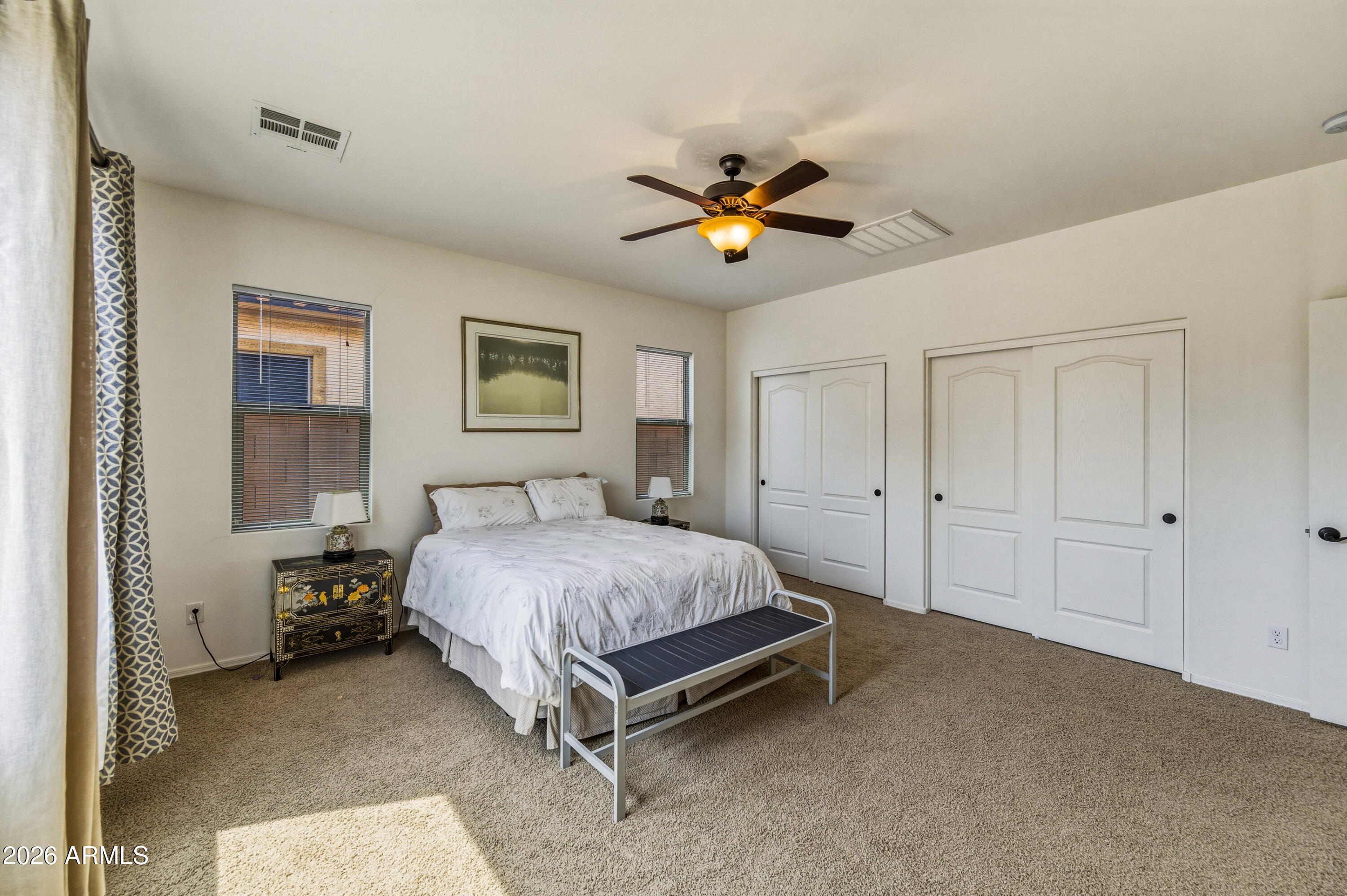 38061 West Merced Street Maricopa, AZ 85138 - Photo 25 of 49 a bedroom with a bed and a chandelier