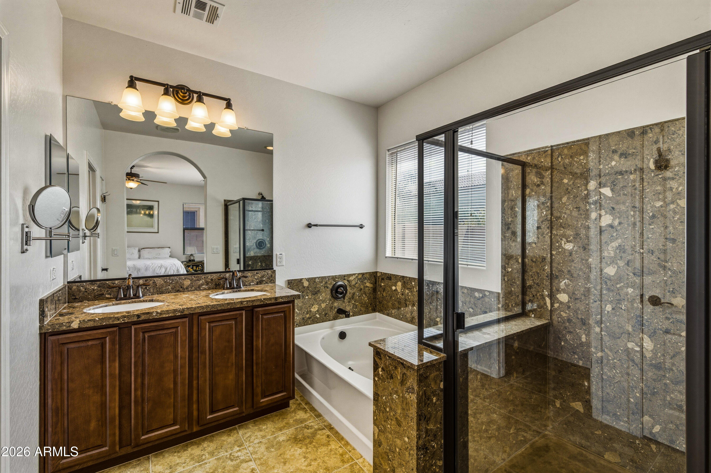 38061 West Merced Street Maricopa, AZ 85138 - Photo 27 of 49 a bathroom with a sink mirror and a bathtub