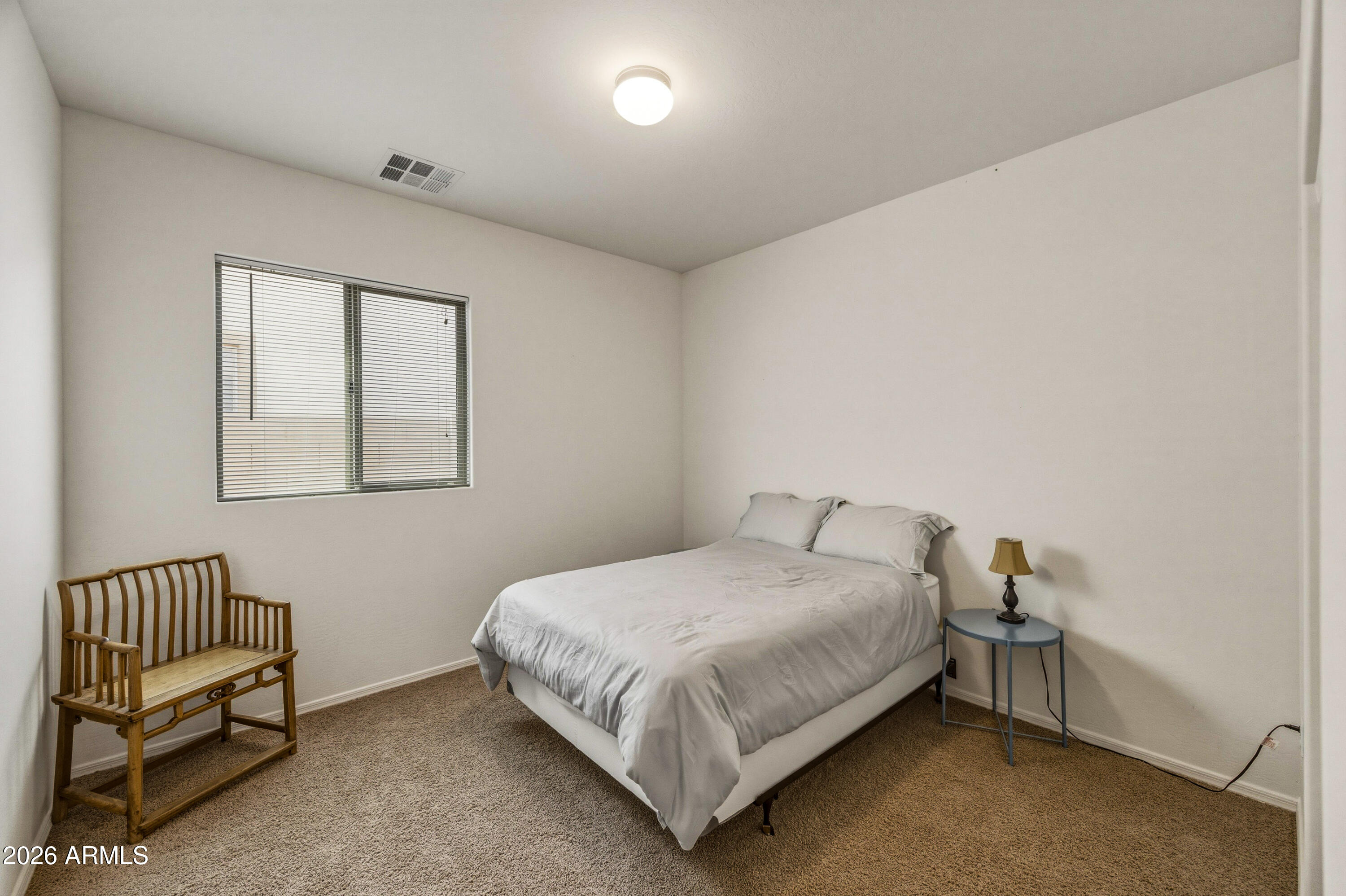 38061 West Merced Street Maricopa, AZ 85138 - Photo 32 of 49 a bedroom with a bed and a window