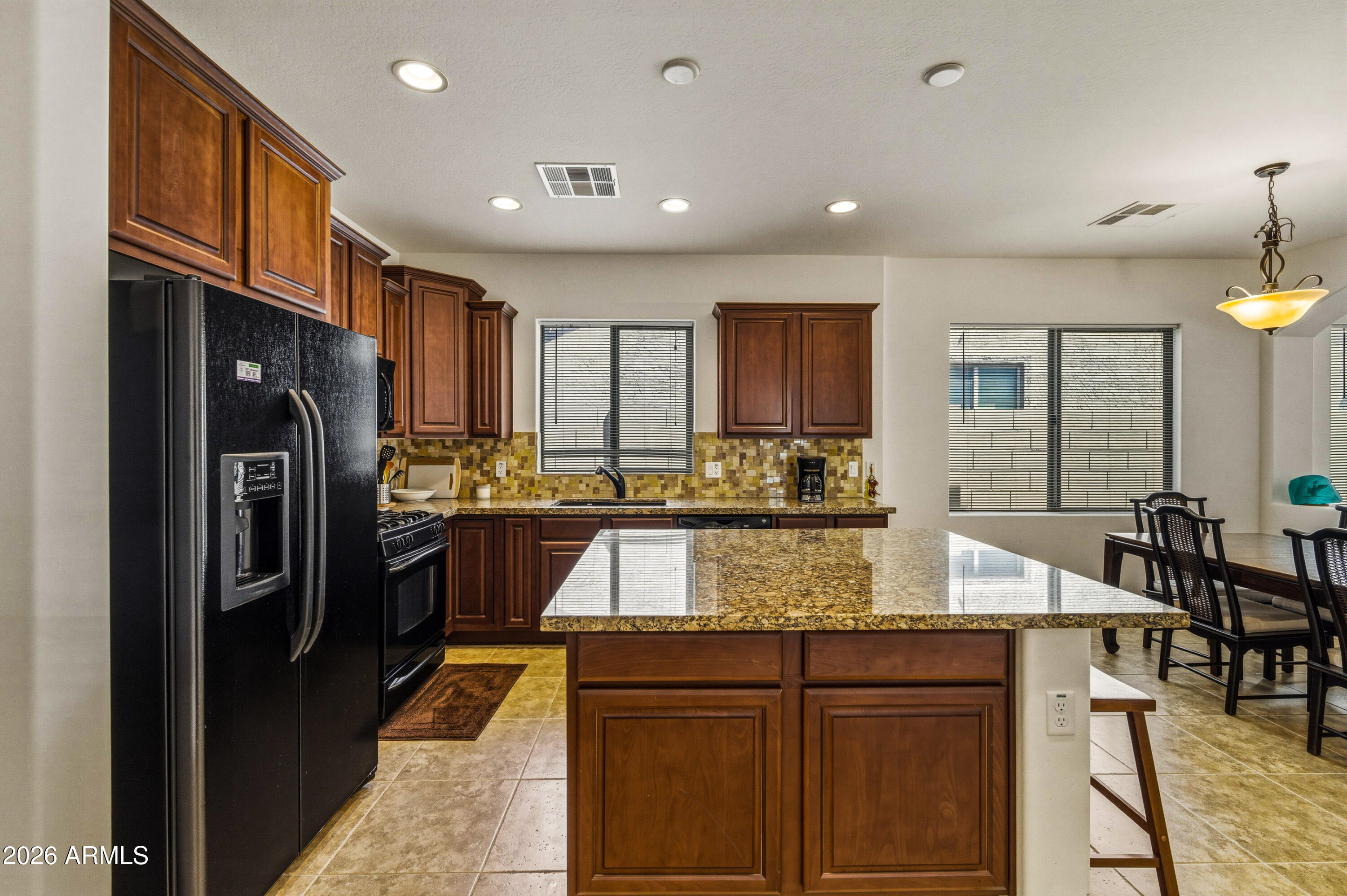 38061 West Merced Street Maricopa, AZ 85138 - Photo 35 of 49 a kitchen with stainless steel appliances granite countertop a refrigerator and a sink