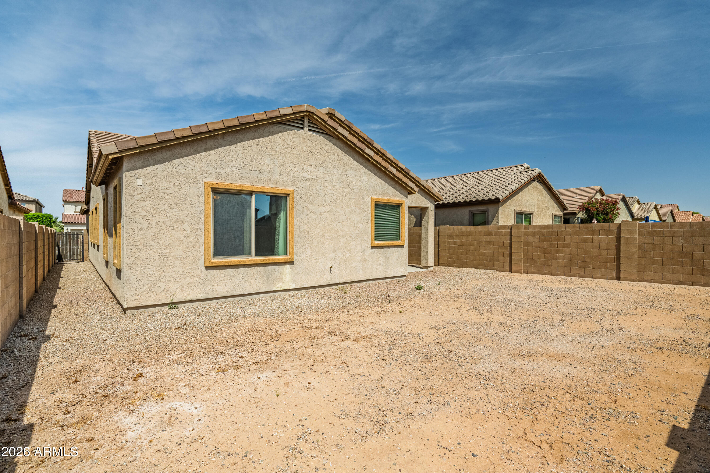 38061 West Merced Street Maricopa, AZ 85138 - Photo 38 of 49 a view of a house with wooden fence