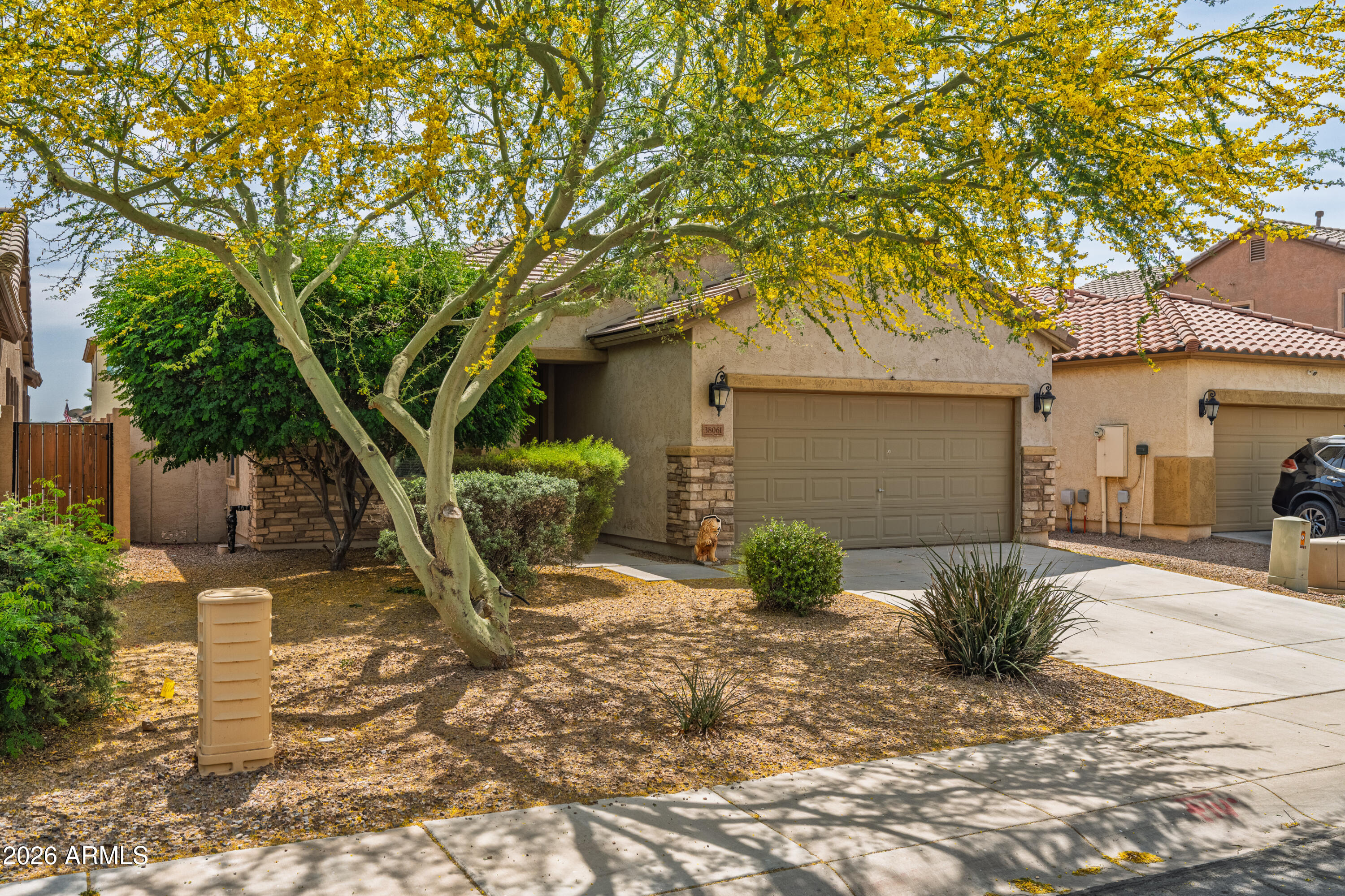 38061 West Merced Street Maricopa, AZ 85138 - Photo 3 of 49 a front view of a house with garden