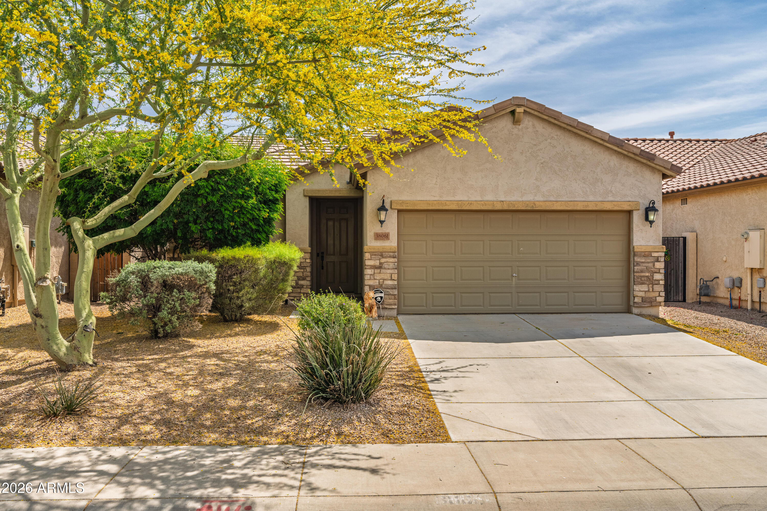 38061 West Merced Street Maricopa, AZ 85138 - Photo 4 of 49 a front view of a house with garden