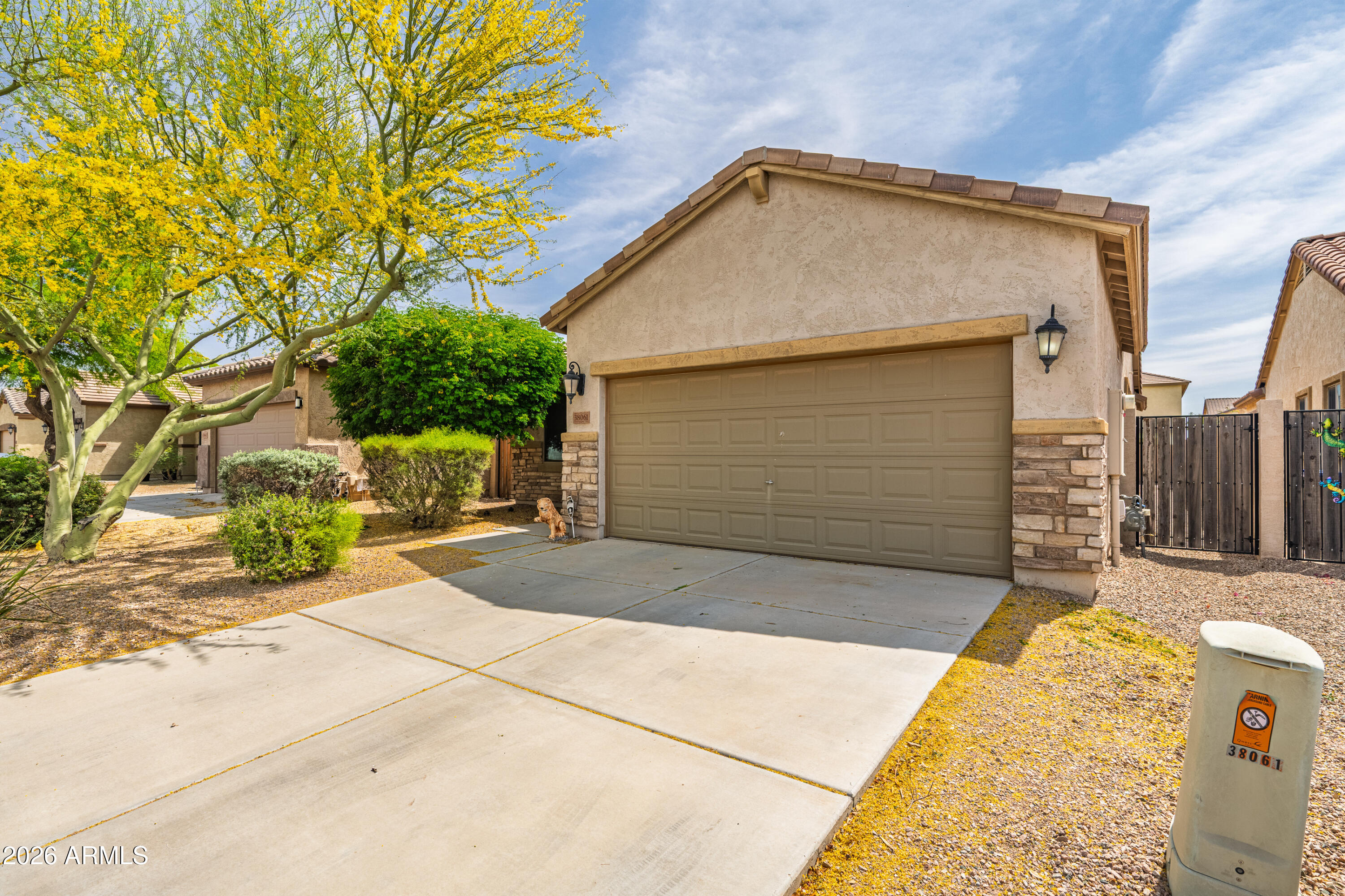 38061 West Merced Street Maricopa, AZ 85138 - Photo 6 of 49 a front view of a house with a garage