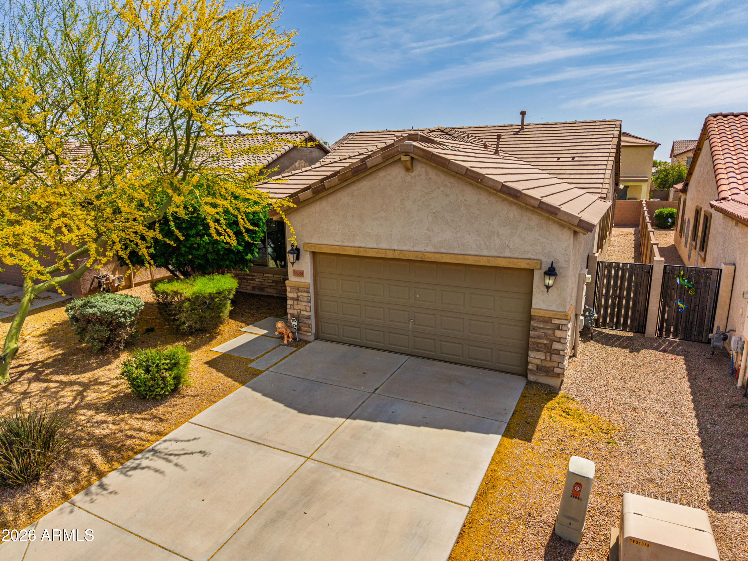 38061 West Merced Street Maricopa, AZ 85138 - Photo 9 of 49 a front view of a house with a yard