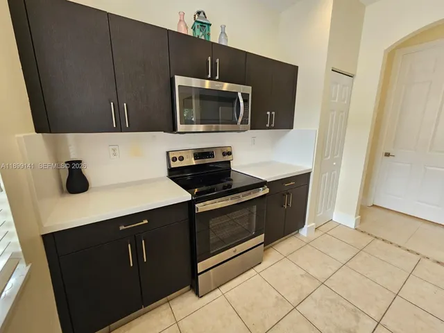 a kitchen with stainless steel appliances a sink dishwasher stove and microwave