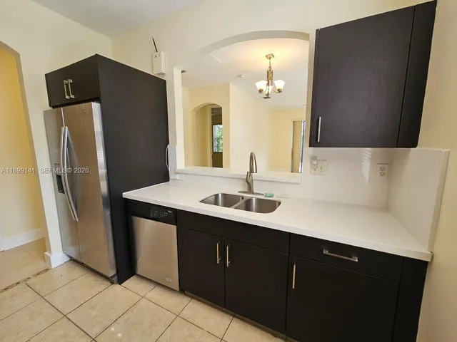 a kitchen with a sink and refrigerator