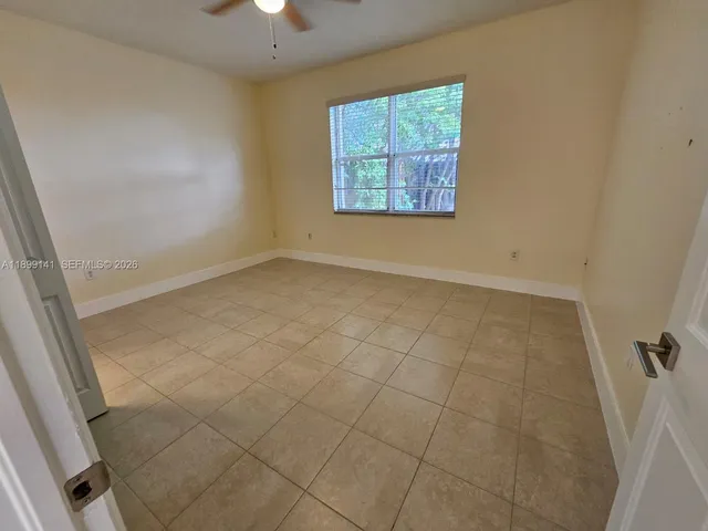 an empty room with windows and entrance
