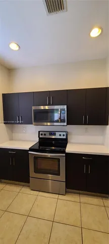 a kitchen with a stove and a microwave