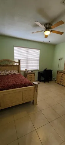 a view of a livingroom with wooden floor and windows