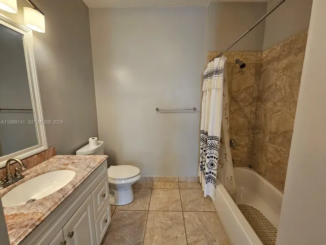 a view of a yard with wooden fence