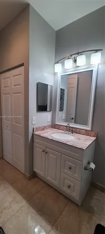 a bathroom with a double vanity sink and mirror