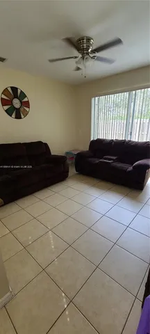 a bedroom with a bed a window and a potted plant