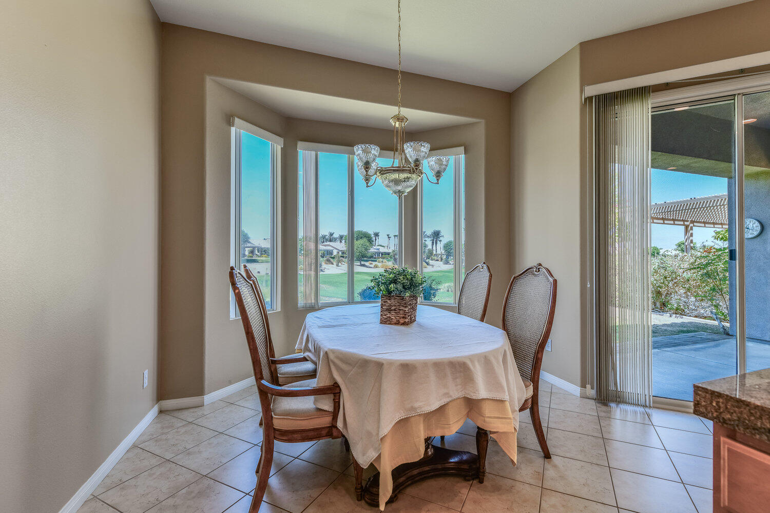 80538 Knightswood Road Indio, CA 92201 - Photo 14 of 32 a view of a dining room with furniture window and wooden floor