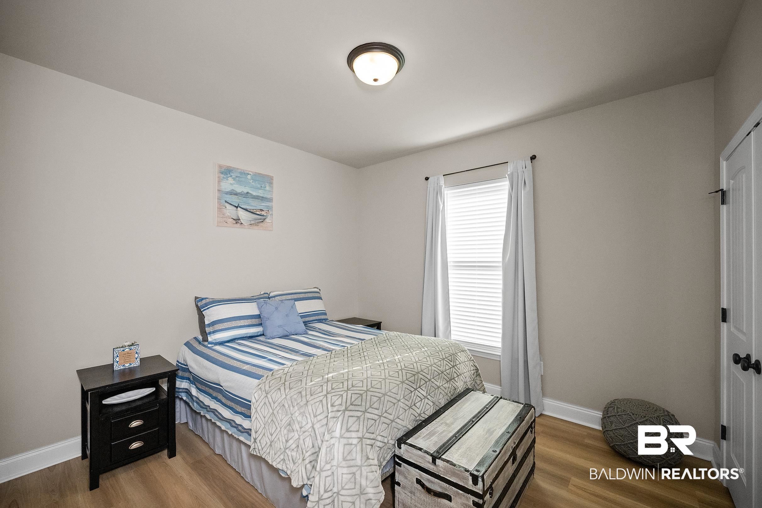 1077 Stella Road Foley, AL 36535 - Photo 15 of 27 Bedroom featuring baseboards and wood finished floors