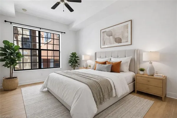 a bedroom with bed and a large window