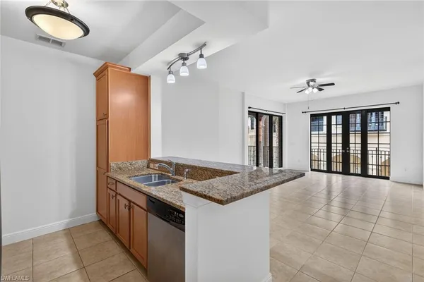an empty room with fan and windows