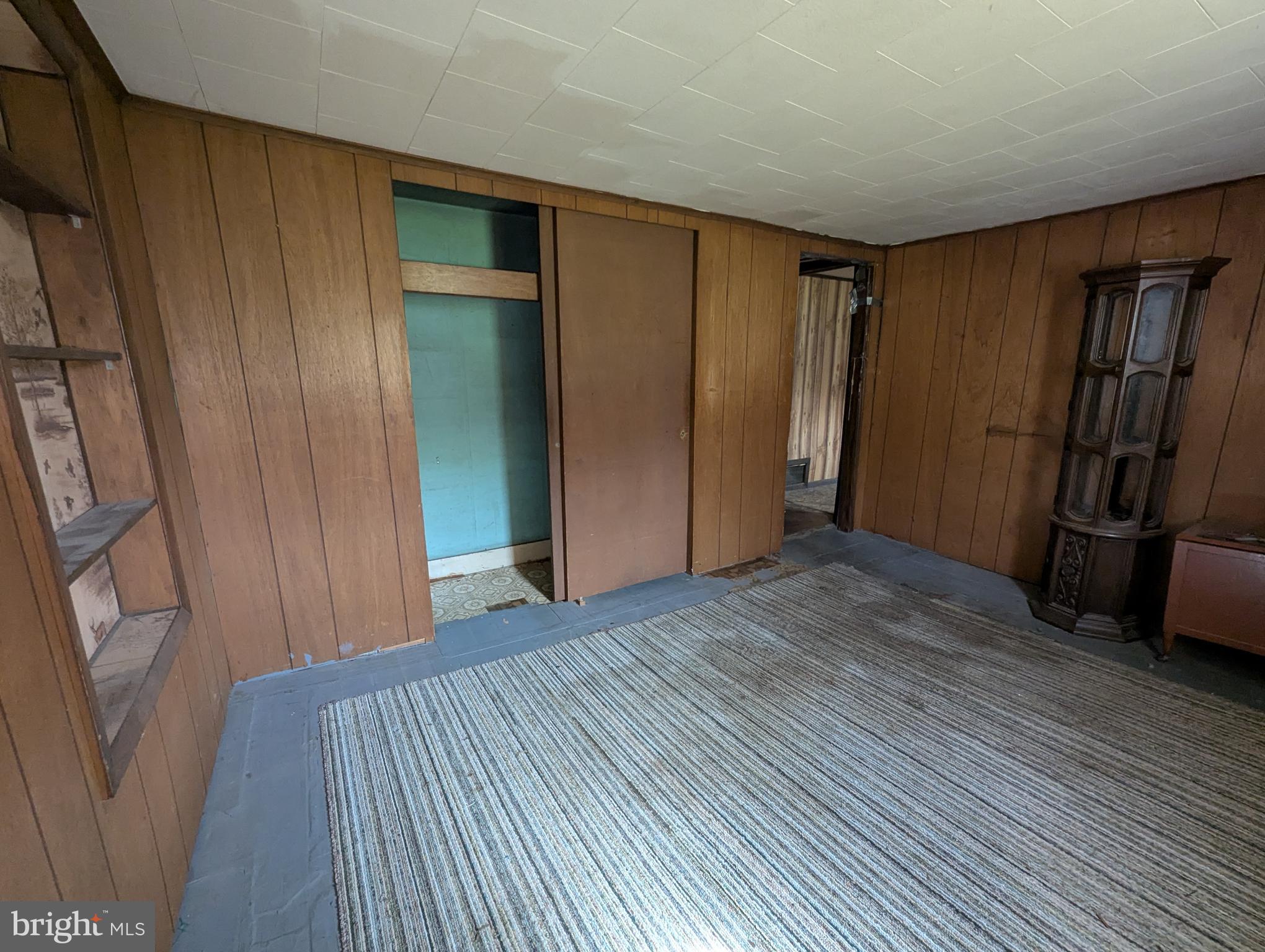 24001 Perry Hill Road Barton, MD 21521 - Photo 36 of 37 a view of an empty room with wooden floor and stairs