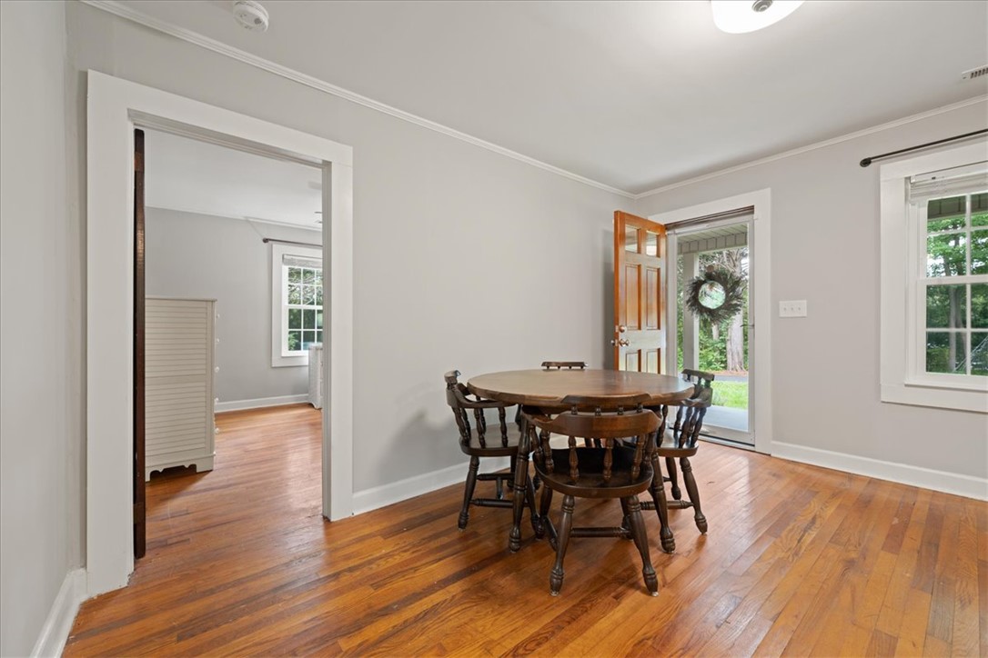174 Holliday Road Six Mile, SC 29682 - Photo 12 of 49 Original wood floors span this inviting interior space, bathed in natural light from the expansive NEW WINDOWS and entry
