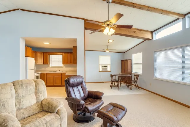 a kitchen with stainless steel appliances granite countertop a refrigerator a sink a stove and a refrigerator