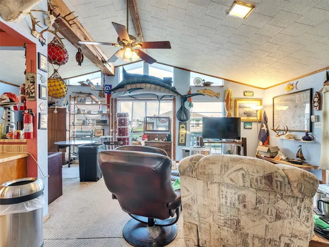 a living room with a bed furniture and a chandelier