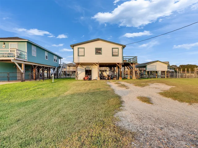 a front view of a house with swimming pool table and chairs
