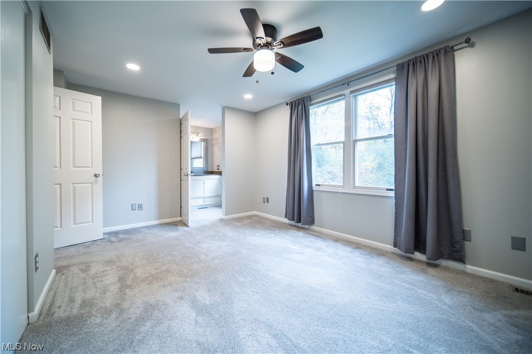 129 Quaker Ridge Drive Akron, OH 44313 - Photo 14 of 20 Carpeted empty room with ceiling fan
