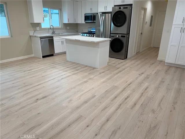 a view of a kitchen with a sink cabinets and a wooden floor