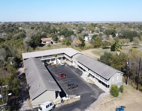 an aerial view of a residential houses with city view