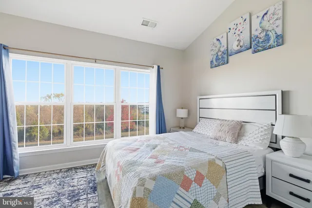 a bedroom with a large bed and a window