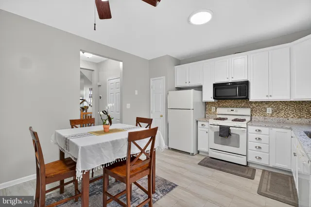 a kitchen with a stove a sink and a refrigerator