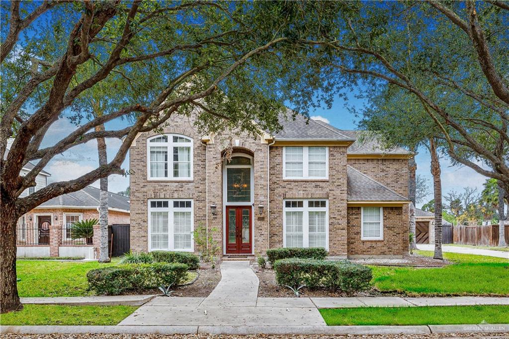 a front view of a residential apartment building with a yard