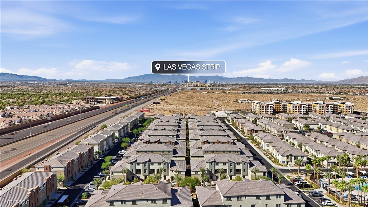 12240 Golden Wreath Road, Unit 2 Las Vegas, NV 89183 - Photo 24 of 29 An aerial perspective showcases the surrounding neighborhood under clear blue skies.