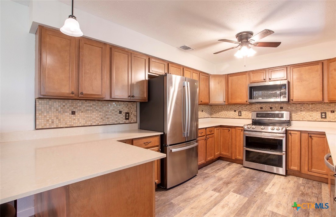 188 Cavalry Road Victoria, TX 77905 - Photo 15 of 30 a kitchen with cabinets stainless steel appliances and a window