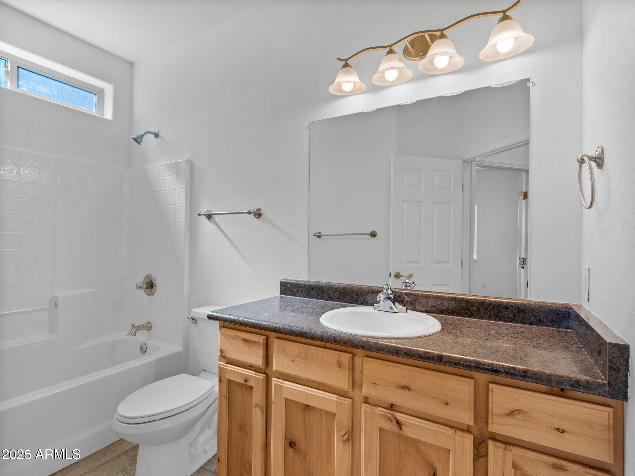 907 Quarter Horse Road Williams, AZ 86046 - Photo 15 of 26 a bathroom with a granite countertop sink a toilet a mirror and shower