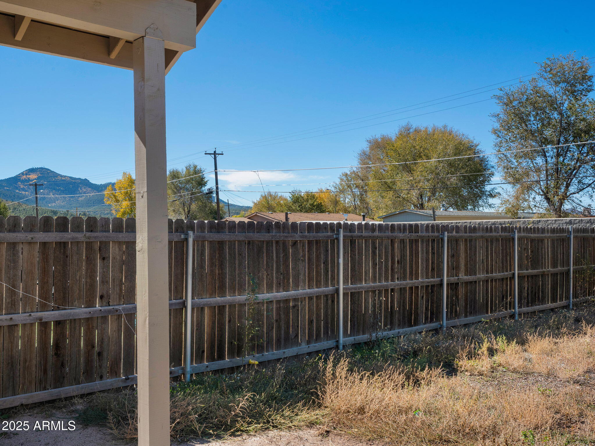 907 Quarter Horse Road Williams, AZ 86046 - Photo 23 of 26 a view of a backyard with a fence