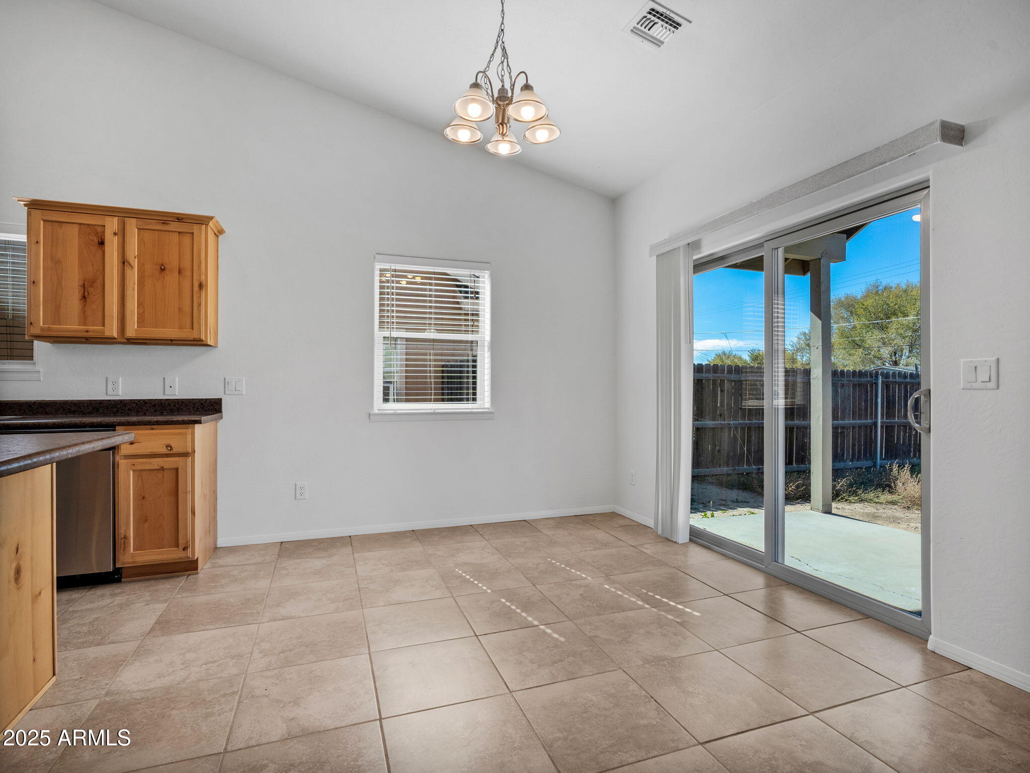 907 Quarter Horse Road Williams, AZ 86046 - Photo 7 of 26 a view of an empty room with window and cabinet