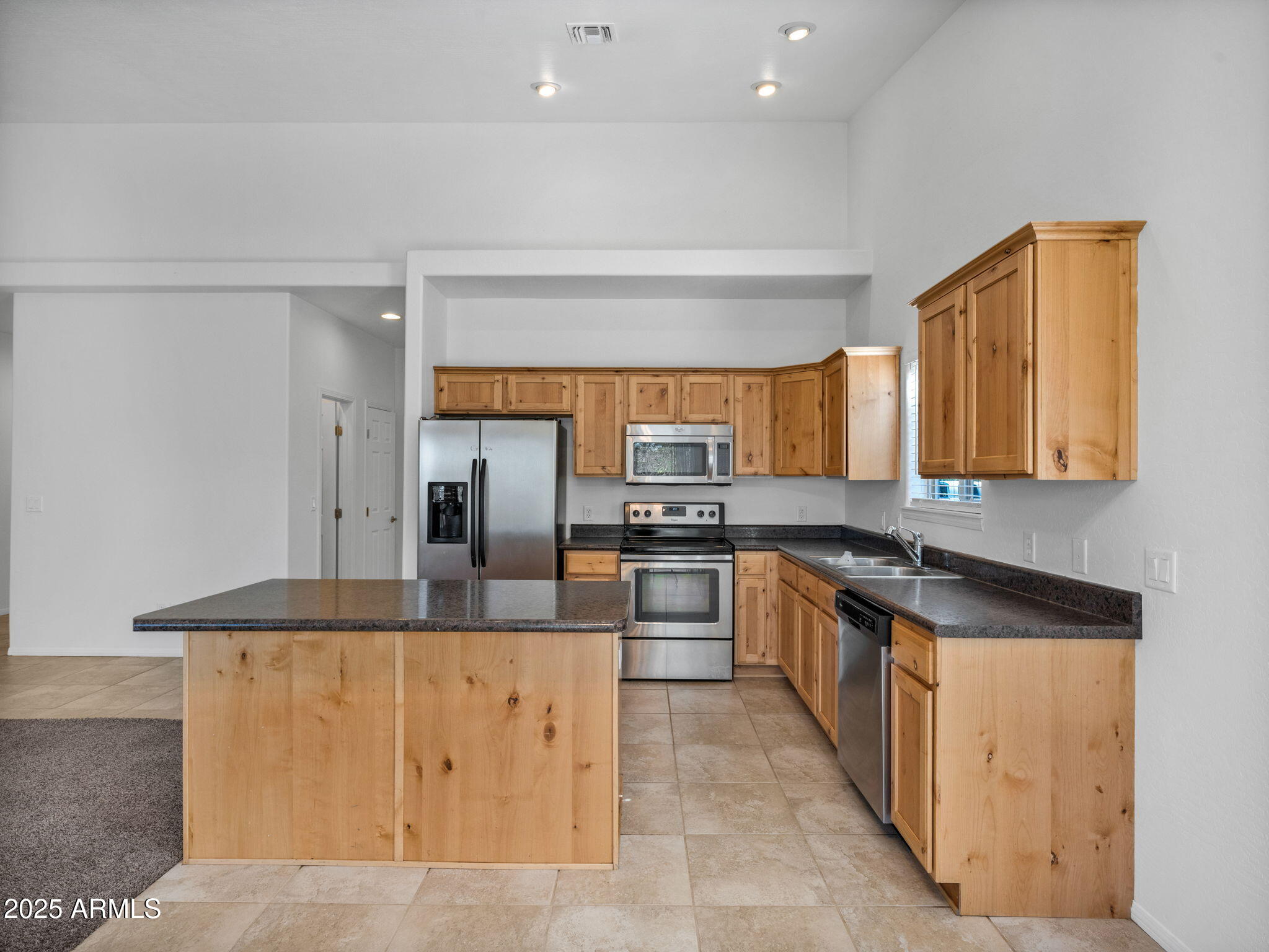 907 Quarter Horse Road Williams, AZ 86046 - Photo 8 of 26 a kitchen with stainless steel appliances granite countertop a sink and cabinets