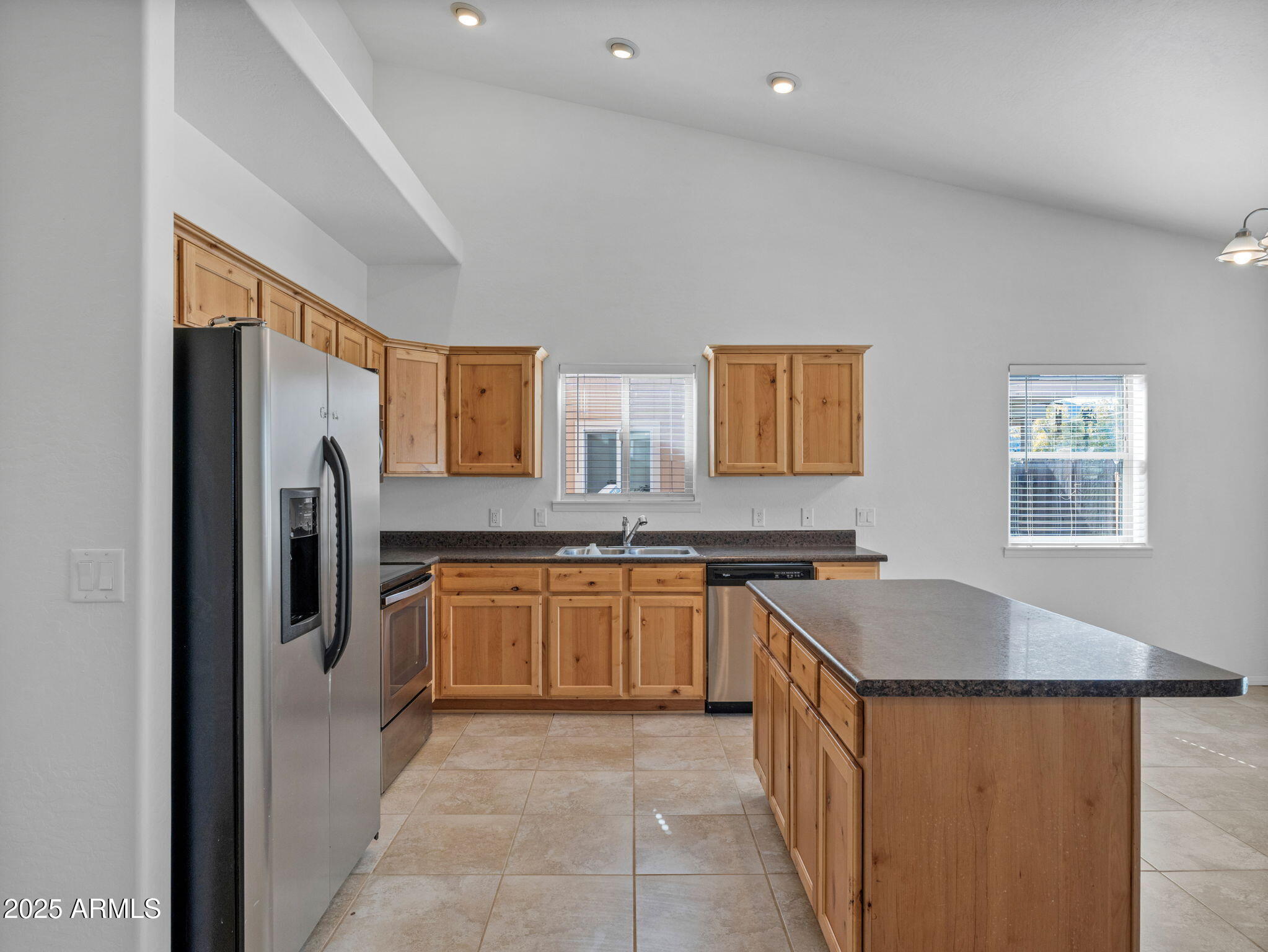 907 Quarter Horse Road Williams, AZ 86046 - Photo 9 of 26 a kitchen with stainless steel appliances granite countertop a sink and a refrigerator